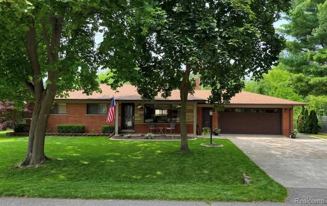 All-brick ranch at 7481 Flickinger Drive, Shelby Township, with mature shade trees