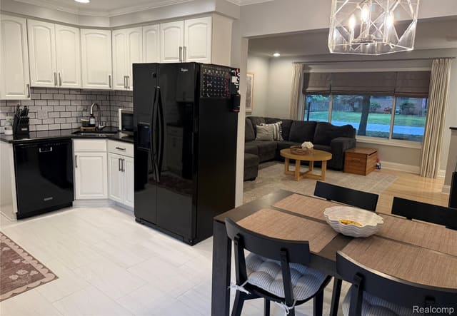 Open kitchen and dining area with modern pendant lighting