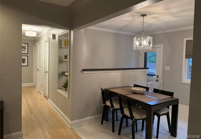 Hallway with hardwood flooring leading to the dining area
