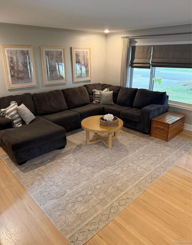 Living room sectional beneath a large picture window