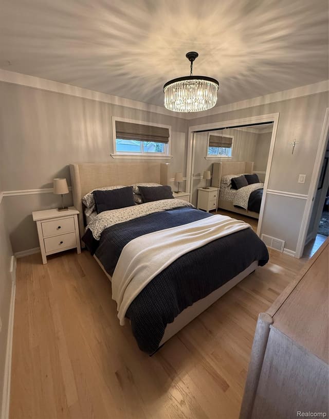 Primary bedroom with mirrored closet doors