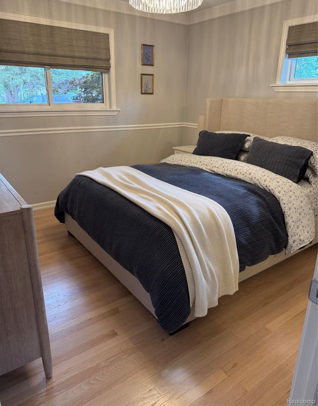 Bedroom with hardwood flooring and chair rail