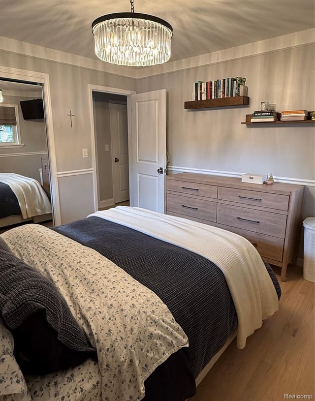 Bedroom with dresser and display shelving