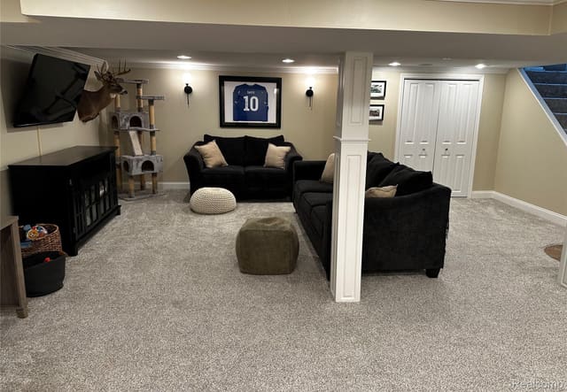 Finished basement media area with sectional seating