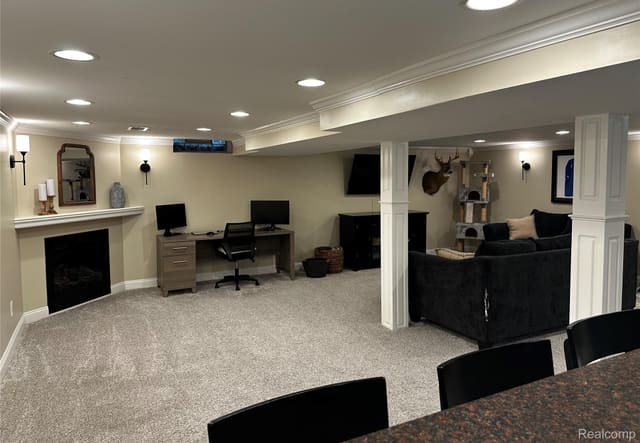 Finished basement recreation area with dedicated workspace